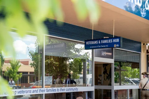 Front of the Wodonga Veterans and Families Hub building with a sign above the entrance, large glass windows, and a pathway leading to the door.
