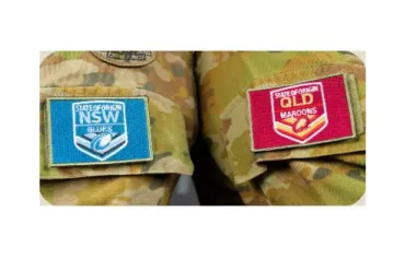 NSW Blues and QLD Maroons lapels displayed side by side on Ary uniforms