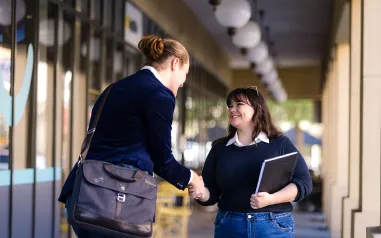 Two people shaking hands. 