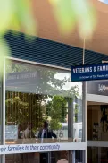 Front of the Wodonga Veterans and Families Hub building with a sign above the entrance, large glass windows, and a pathway leading to the door.