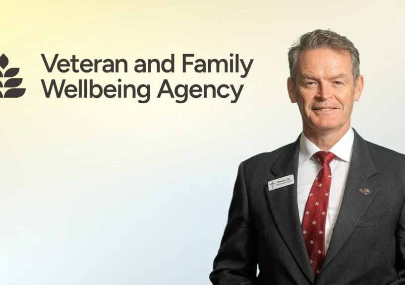 Veteran and Family Wellbeing Agency. Man in suit smiling. 