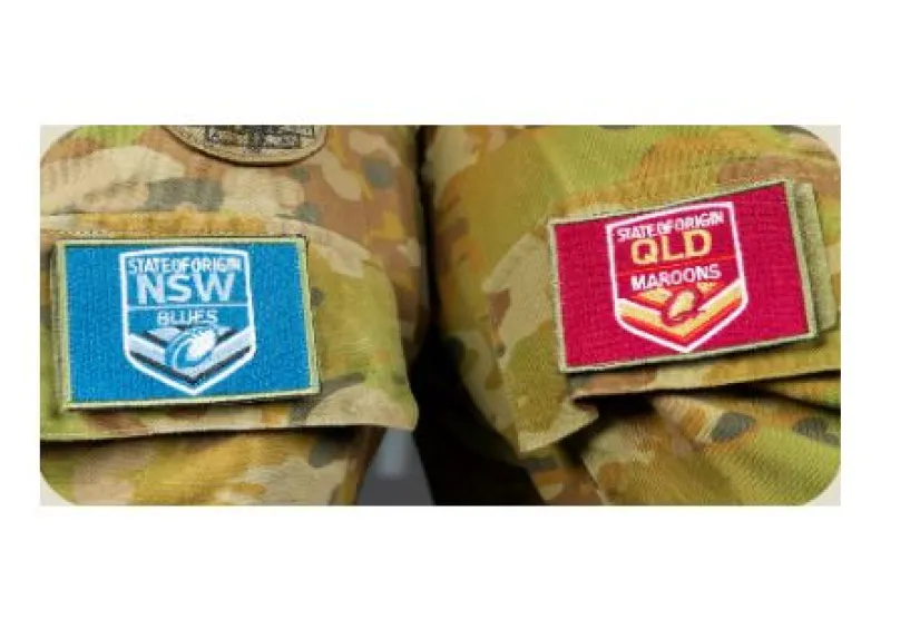 NSW Blues and QLD Maroons lapels displayed side by side on Ary uniforms