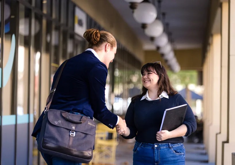 Two people shaking hands. 
